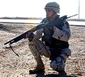 A US soldier in Ar Ramadi, Iraq in 2004 armed with a Mossberg 500