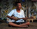 A teacher of traditional music at his house in Mae On, just outside Chiang Mai, plays a sueng (Thai script: ซึง, pronounced as "suh-ng"), a string instrument from northern Thailand.