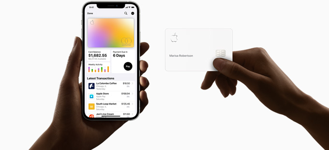 One hand holding an iPhone with financial information on screen and other hand holding an Apple Card