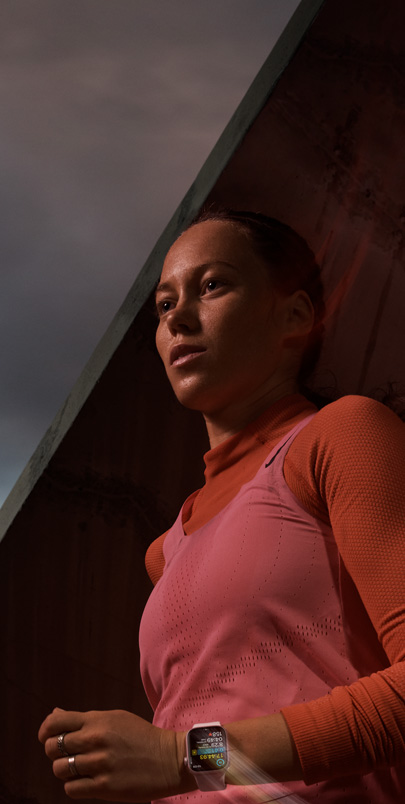 A woman wearing Apple Watch Series 9 while tracking a running workout.