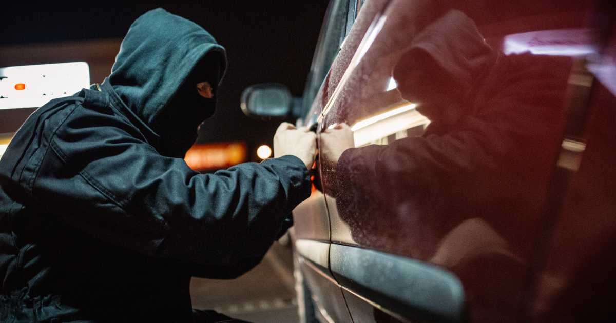 thief opening a car