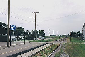 A small railway platform next to a single track