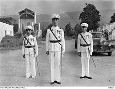 Portuguese governor Senhor Manuel Ferreira de Carvalho welcomes the Australians in 1945.