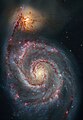 M51's spiral arms and dust lanes clearly sweep in front of its companion galaxy.