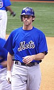 A baseball player on-deck, taking practice swings before his at-bad.