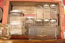 Color picture of old kitchen glassware in a wooden cabinet