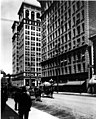 Looking north. Shows IXL Clothing Co. at 425-7 Riverside Ave., and Old National Bank at Riverside Ave., northeast corner of Stevens in 1914.