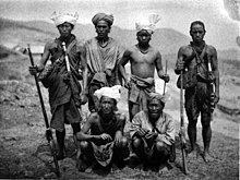 Photo of six Sizang chiefs. Four are standing, and two are crouching in front.