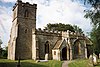 Stone building with square tower.