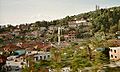 A mosque and some houses on a hill in Peshkopi