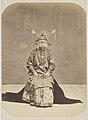 Chinese Bride in Batavia in her wedding dress, 1870. The dress is heavily influenced by Chinese culture but also shows subtle differences.