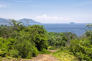 View east from the hill on the western side of the port: Candidasa over the wider bay, and the rock of Gili Bia[25] jutting out in the Lombok Strait