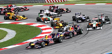 The opening corner of the 2010 Malaysian Grand Prix being led by eventual world champion Sebastian Vettel