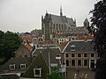 View towards the southeast from the top of the steps, showing the Hooglandse Kerk in the distance, and the back of the wrought iron gate and the Herenlogement in the foreground.