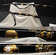 Black lacquered hanamaru mon maki-e raden daishō koshirae (sword mounting). Meiji period.