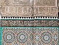 Example of geometric motifs in zellij tilework (below) and calligraphy in tile and carved stucco (above), at the Bou Inania Madrasa