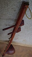 Vietnam. Bro with tuning pegs for wire strings, resonator gourd.