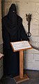 Robed figure of a medieval public executioner at the Museum of Torture in San Marino