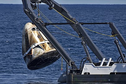 Crew Dragon being lifted from the water and onto the vessel after the Demo-1 mission, 8 March 2019