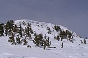 The summit of San Jacinto Peak covered by a cornice formed by wind-blown snow