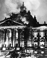 black-and-white photo of a building on fire