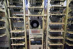 Three tall racks containing electronic circuit boards