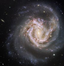 Spiral galaxy Messier 61 is aligned face-on towards Earth.[۱]