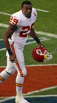 Eric Berry in a Kansas City Chiefs uniform and holding his helmet.