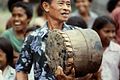 Musician playing tifa drum during tug-of-war matches at Ullath.