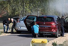 FSP gendarmes extract the VIP from his vehicle and escort him to theirs