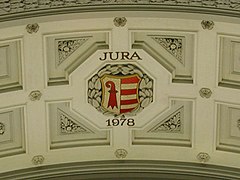 Escudo de Armas del Jura en un arco.