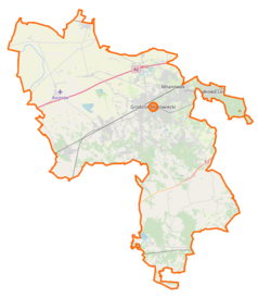 Mapa konturowa powiatu grodziskiego, blisko centrum u góry znajduje się owalna plamka nieco zaostrzona i wystająca na lewo w swoim dolnym rogu z opisem „Stawy Goliana”