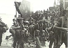 Soldiers disembarking from a landing craft