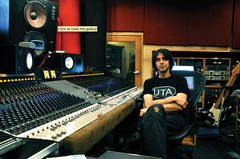 A color photograph of music producer Eric Valentine sitting inside a recording studio.