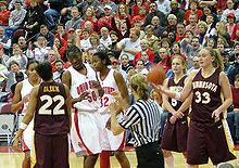 in front of the stands, then team-captain and others discuss a dispute