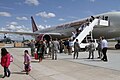 Passengers disembarking from a plane