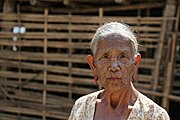 Elderly woman with extensive geometric tattoo across her face