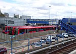Two B07 rolling stock next to an older B90 rolling stock at the Poplar DLR depot next to Poplar DLR Station.