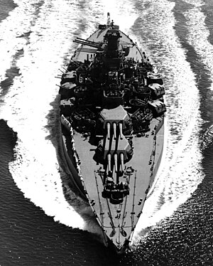 The U.S. Navy battleship USS Tennessee (BB-43) underway on 12 May 1943. Tennessee was damaged in the Japanese attack on Pearl Harbor 7 December 1941 and was afterwards given a very extensive reconstruction. This gave her the enormous beam apparent in this photograph.