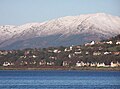 Houses in Kilcreggan west of the pier: the snowy hills in the background are on the other side of Loch Long.