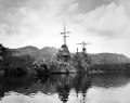 New Orleans under a camouflage net at Tulagi undergoing field repairs suffered in the Battle of Tassafaronga on 1 December 1942. Once field repairs were completed, New Orleans traveled to rear-area ports for further repairs.