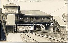 A postcard of a railway station over a four-track railway cut