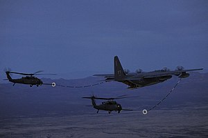 A_U.S._Air_Force_HC-130J_Combat_King_II_aircraft_conducts_aerial_refueling_with_two_HH-60G_Pave_Hawk_helicopters_during_exercise_Angel_Thunder_2013_near_Davis-Monthan_Air_Force_Base,_Ariz.,_on_April_11,_2013_130411-F-PD696-245