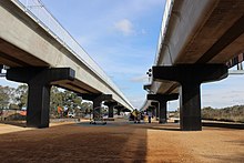 A playground underneath the train bridge