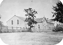 Black and white photograph of a St. Patrick's Church and the street in front