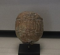 Bulle en argile qui scellait les liens d'un ballot, avec impression du sceau de Naram-ili, fonctionnaire sous le règne de Shulgi. Musée du Louvre.