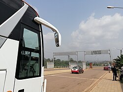 Vehicles driving by the Ghana–Ivory Coast border