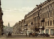 A photochrom print (color photo lithograph) showing Nikolayevskaya street and the facade of the hotel "Continental" in Kyiv on a sunny day