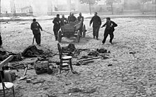 People collecting refuse in a wagon