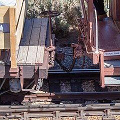 Dual coupling between link & pin system with a knuckle coupler. The knuckle component has been removed, allowing a pin to drop in the vertical hole in the head to mate with the link forming an ad-hoc coupler.